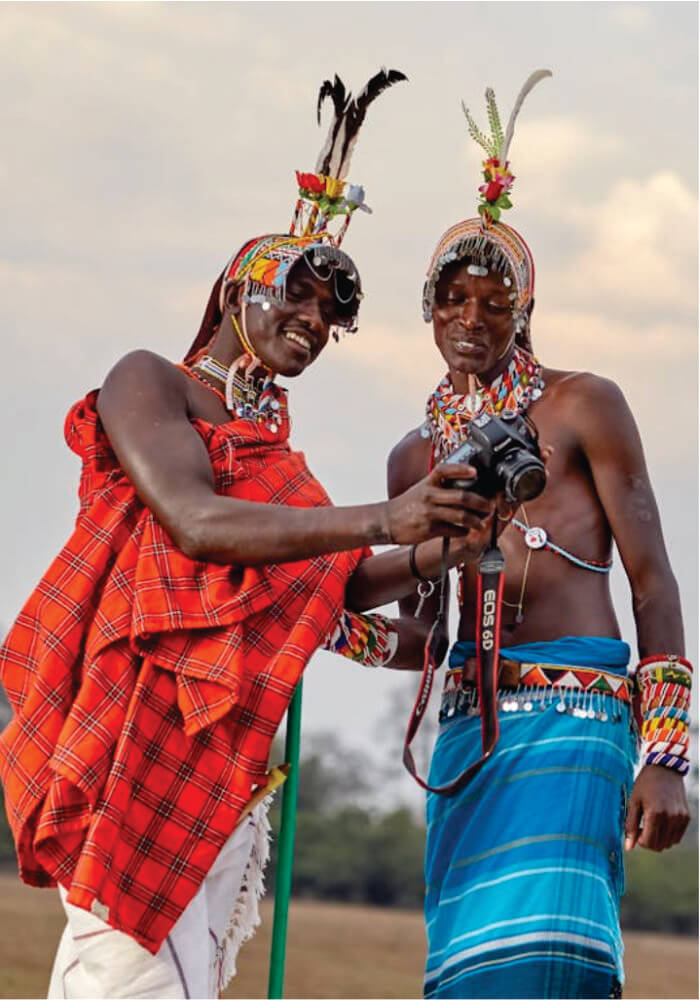 An image of two Masai men showing a camera while wearing traditional clothing.