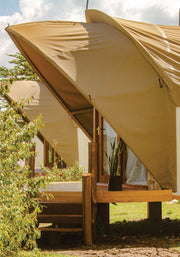 Clear view of two tented camps in beige canvas with wooden verandah at budget lodge in Masai Mara for affordable safari adventure